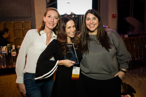 Sari with friends holding award