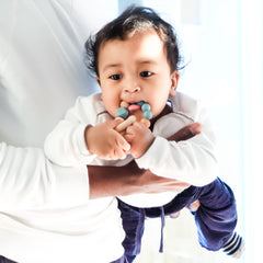 Baby using BooginHead teething rings