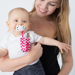 Mom holding baby using BooginHead Pacifier clip