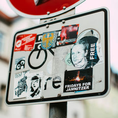 street sign covered in stickers
