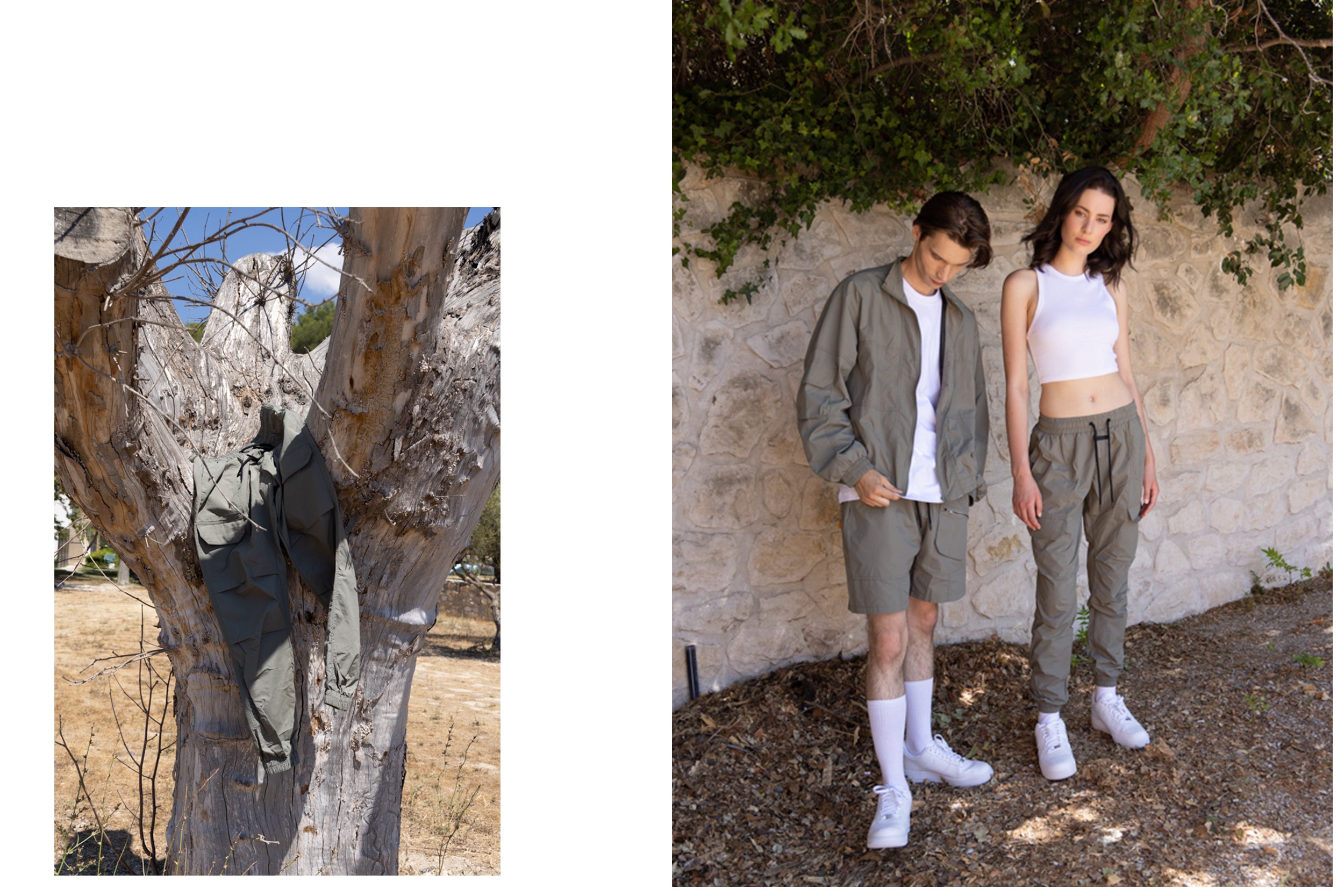 A male model wearing a black zip-up jacket and black cargo pants stands beside a female model wearing a white t-shirt and black cargo shorts, posing in a grassy field.