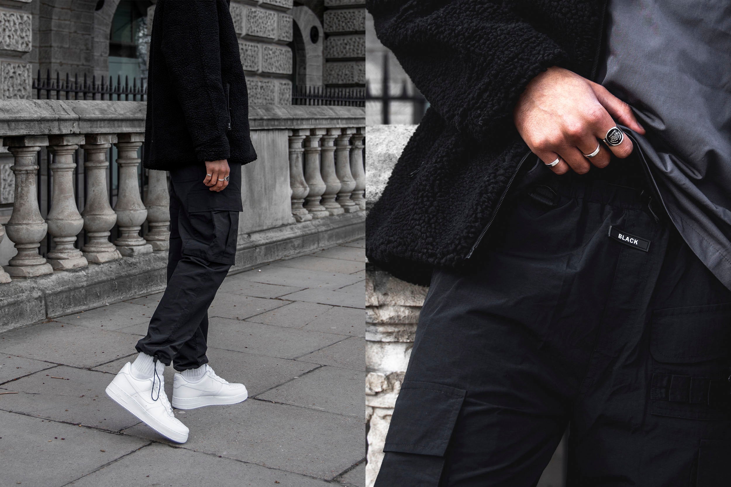 A male model in black jacket and cargo pants standing on the street.