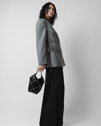 grey jacket black bag black skirt
