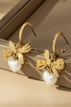 brass bow and pearl heart drop earrings