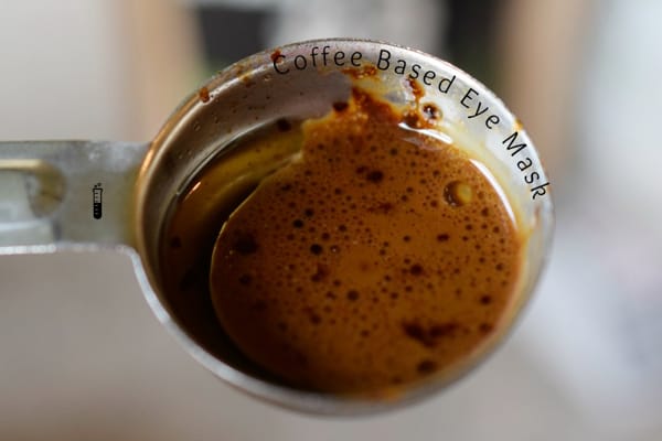 a mixture of coffee and oil in a metal spoon