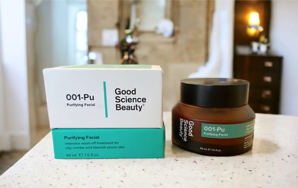 Box and jar of 001-Pu Purifying Facial with bathroom in background