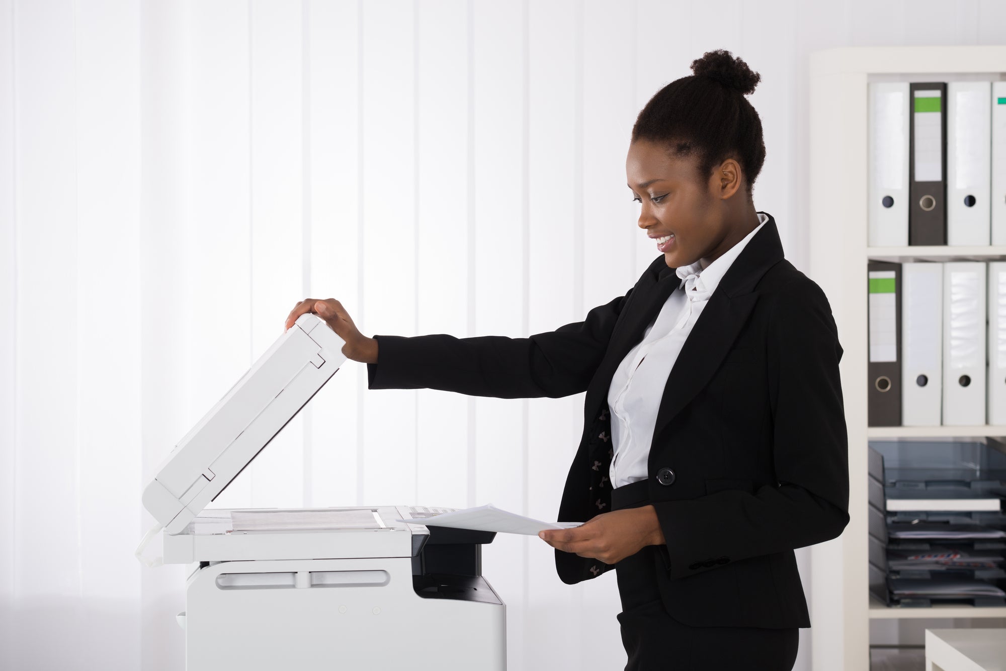 Woman smiling while at a printer