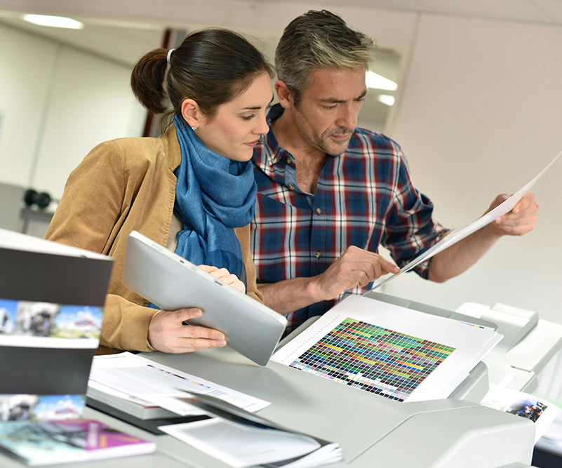 People working together on creative project with production printer