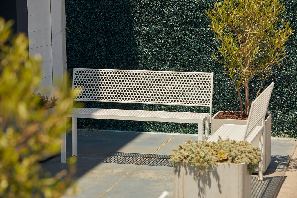 custom white perforated steel outdoor benches at a retail shop in Los Angeles