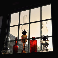 Glass lanterns displayed in a window.