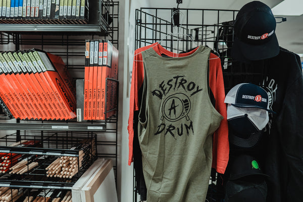 We’re not your average apparel for drummers, marching band students, or drum set players. Drummer’s clothing taken up a notch; Destroy A Drum has a wide selection of drum Tees, drummer's Outerwear, drum performance Headwear, & drumset Accessories with clean cut styles & crazy artwork designs. Shop the best in drum clothing and drummer's outfits for any kind of drummer. Drummer's apparel made with drum designs including t-shirts, hoodies, baseball tees, & more. Drum clothing that speaks for your character & personality on & off the stage; whether you're a drummer, percussionist, in marching band, or representing your passion through our company motto. Destroy A Drum has the drum gear to make you ready to DESTROY