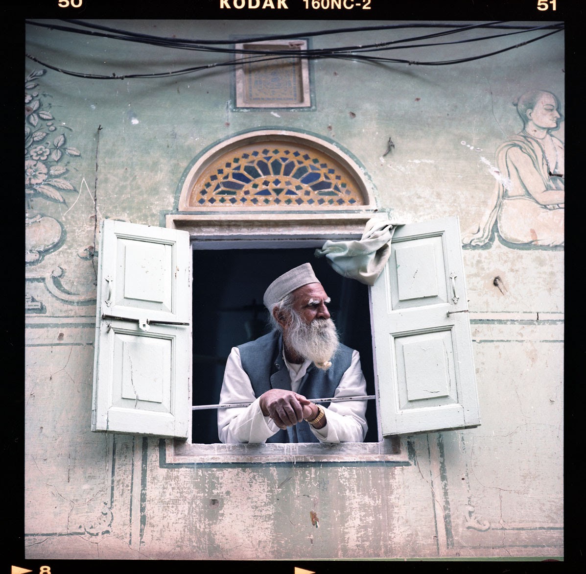 A moment of a man looking out his window is captured beautifully. Photo by Jonas Spinoy.