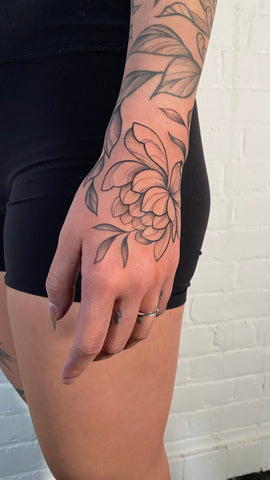 floral hand piece by female tattoo artist Lu Loram Martin, in Toronto, Canada