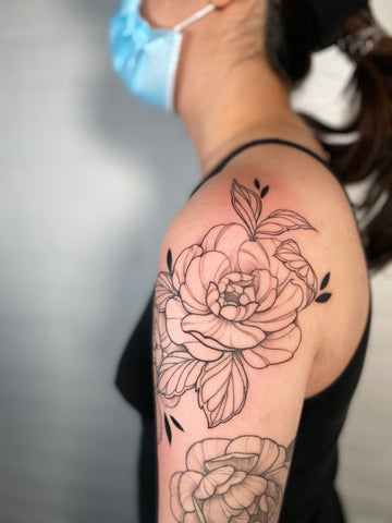 floral shoulder tattoo by artist Lu Loram Martin, in Toronto, Canada