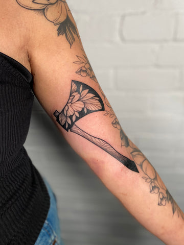 Floral axe tattoo designed by artist Lu Loram Martin, in Toronto, Canada.