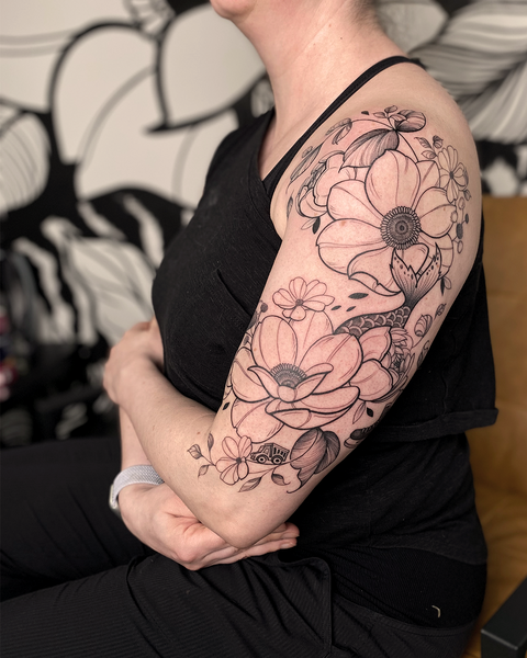 Beautiful feminine floral tattoo by floral tattoo artist, Lu Loram-Martin, in Toronto, Canada