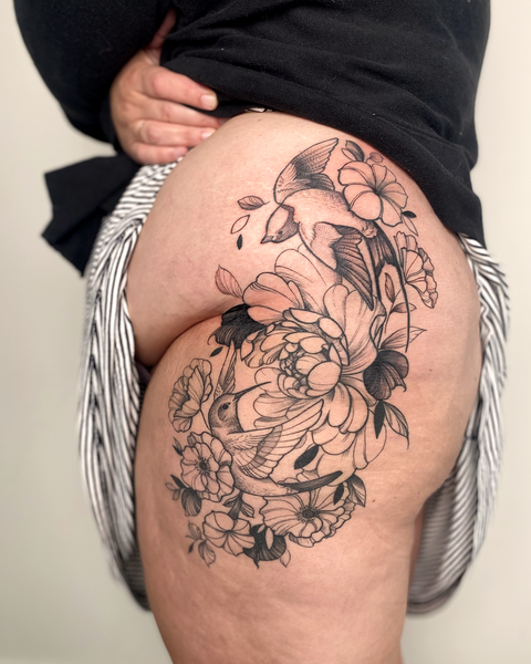 Beautiful feminine floral thigh tattoo with humming bird and swallow and peony, by floral tattoo artist, Lu Loram-Martin, in Toronto, Canada