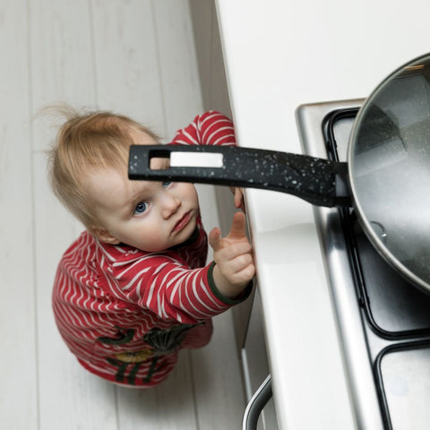 baby reaching for a hot pan
