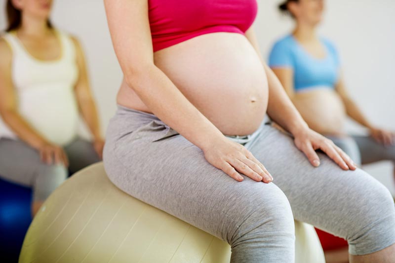 The Correct Birthing Ball Size for Pregnant Women when Sitting is Knees Bent Slightly Below Hips