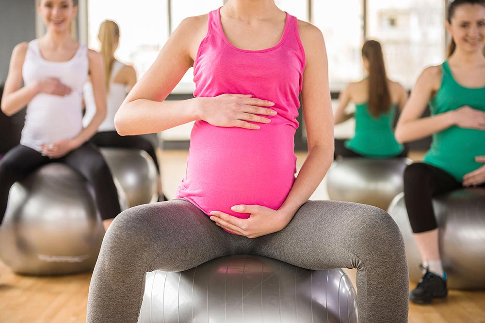 Pregnant Woman Sat on Birth Ball in Prenatal Class