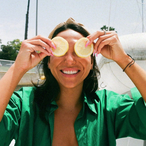 Woman with lemon slices over eyes