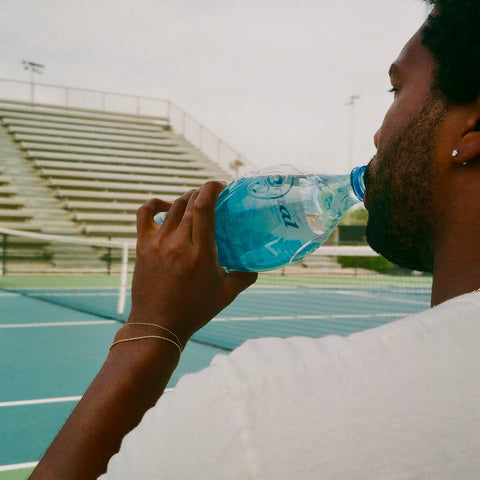 Man drinking Eternal alkaline water at a stadium