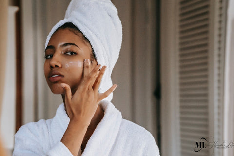 Woman applying facial moisturizer cream - ML Delicate Beauty