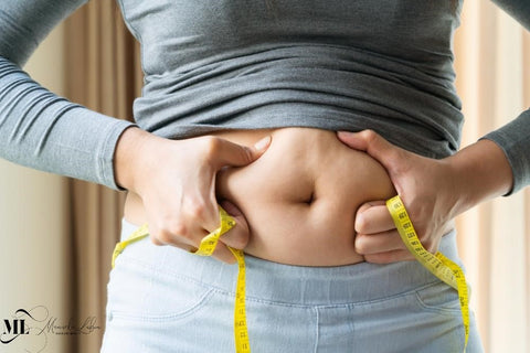 Woman measuring her belly with a measuring tape - ML Delicate Beauty