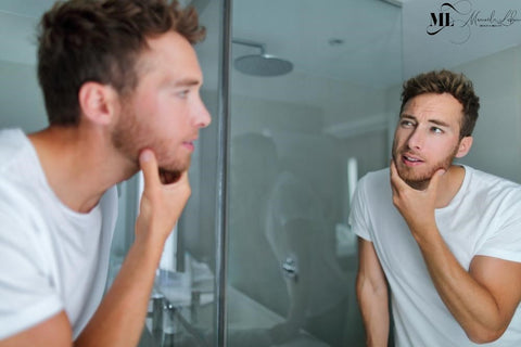 Man checking his face in the mirror - ML Delicate Beauty