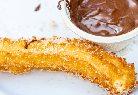 Fried churro with pot of chocolate sauce