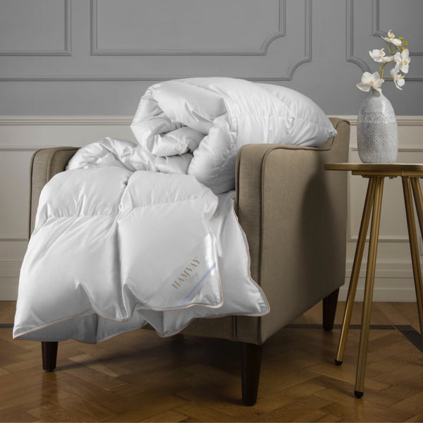 white down comforter folded on a chair