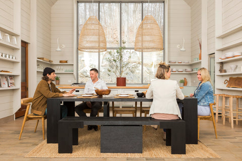 A family siting at a dark table