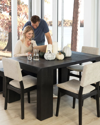 A couple sitting at a Dark Canadian Oak table