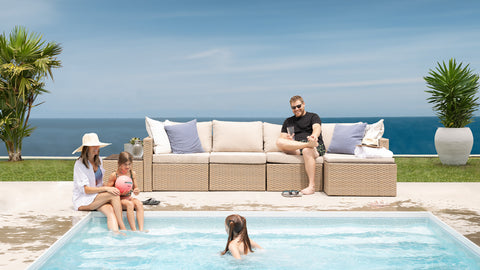 Friends sitting outside by the pool