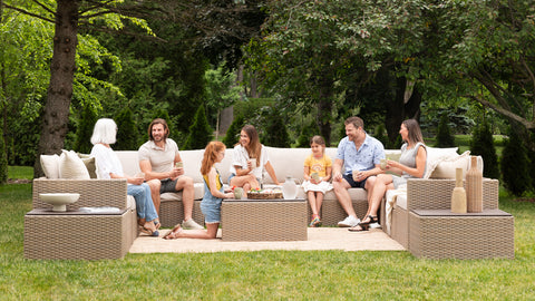 Friends sitting outdoors on a wicker outdoor furniture set