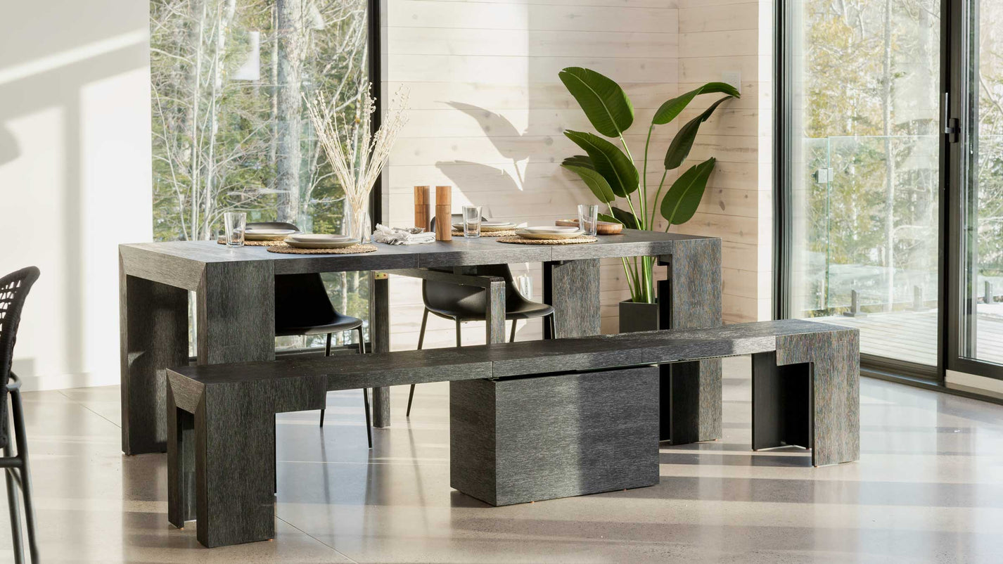 A modern kitchen table in a well lit kitchen.