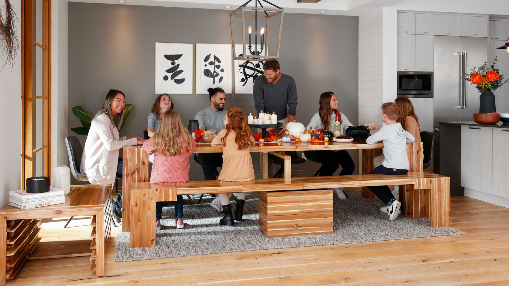 A large family sitting down at a extendable dining table for dinner.