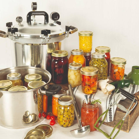 Wide Mouth and Regular Mouth Canning Jars with Canning Accessories next to an All American Canner