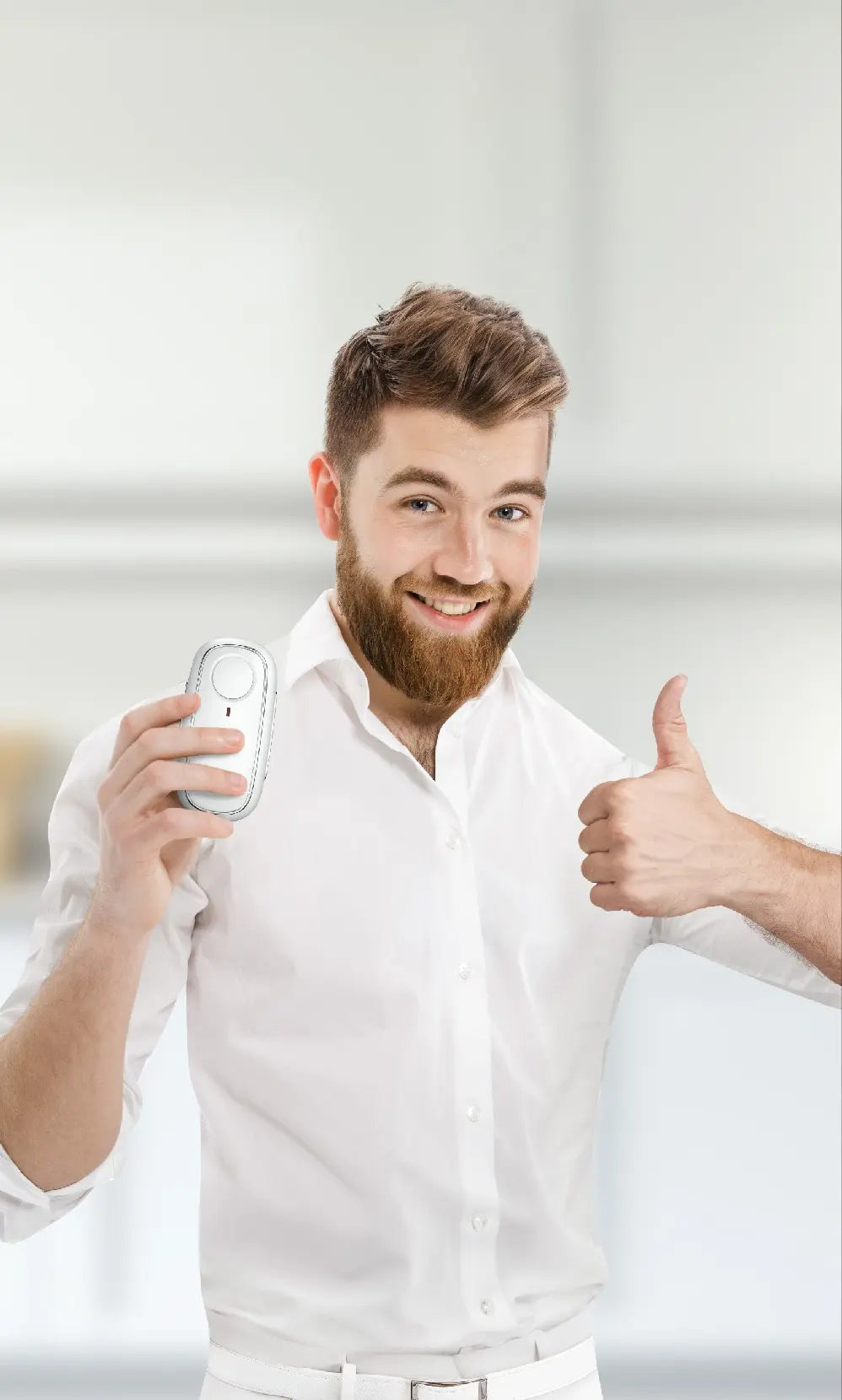A man in a white shirt holds a sleek device in one hand, while extending his other arm in a bright, minimalist setting.