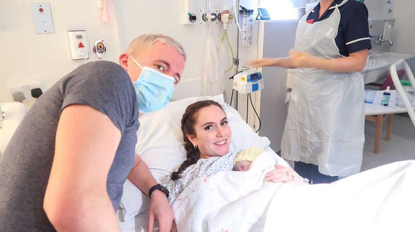 Mother and father with their newborn baby in a hospital