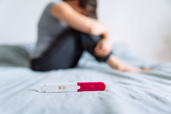 A woman feeling down about her pregnancy test