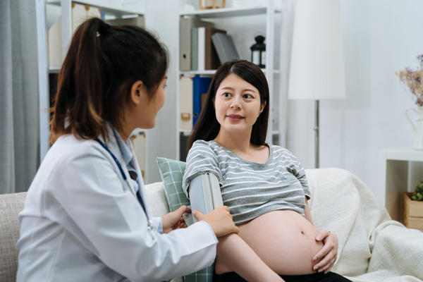 A doctor taking tests on a pregnant woman