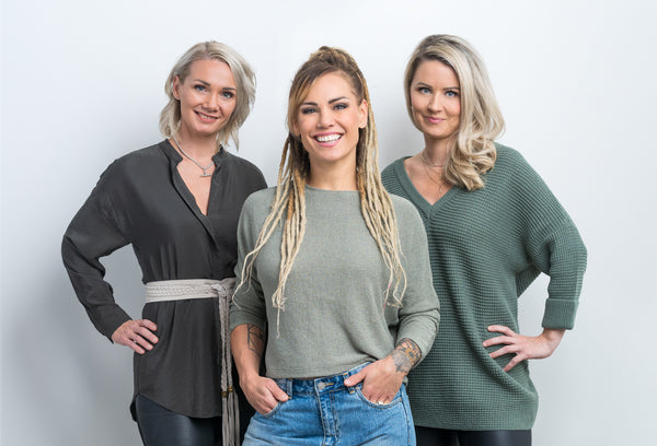 Ex-boxer Eva Wahlström standing in the centre and smiling with Lola&Lykke founders Laura McGrath (left) and Kati Hovikari (right)