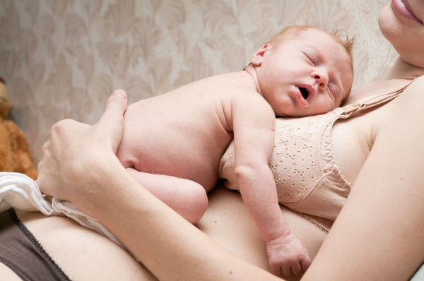 Baby is sleeping on the mother’s lap