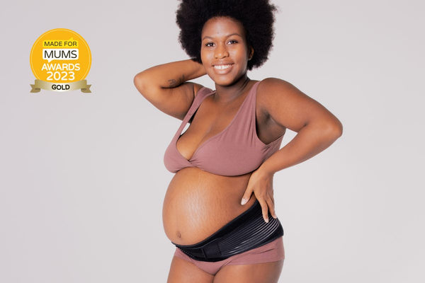 An expecting mother wearing Lola&Lykke award-winning Core Relief Pregnancy Support Belt