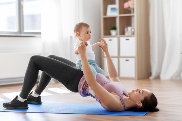 Mother engaging in core-strengthening exercises with her baby, focusing on post-C-section recovery