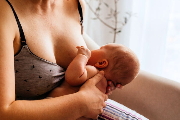 Mother providing nourishment to her baby with a secure and proper latch during breastfeeding