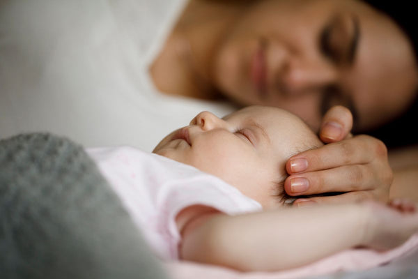 Mother and baby sleeping at home