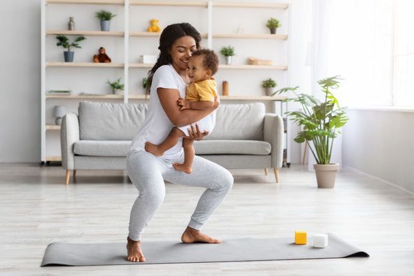 Mother doing gentle post-c-section exercise with her baby