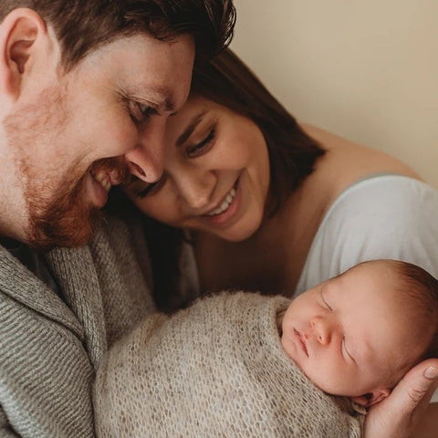 A heartwarming moment as the mother and father share precious time with their newborn baby